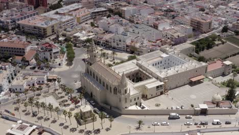 aerial view of a coastal town in spain with church and monastery