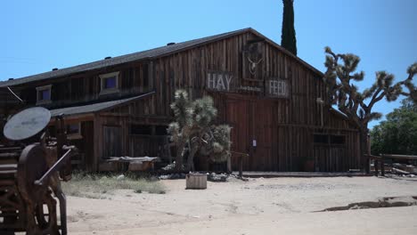 old wooden hay feed barn in desert western style ghost town on a hot summer day