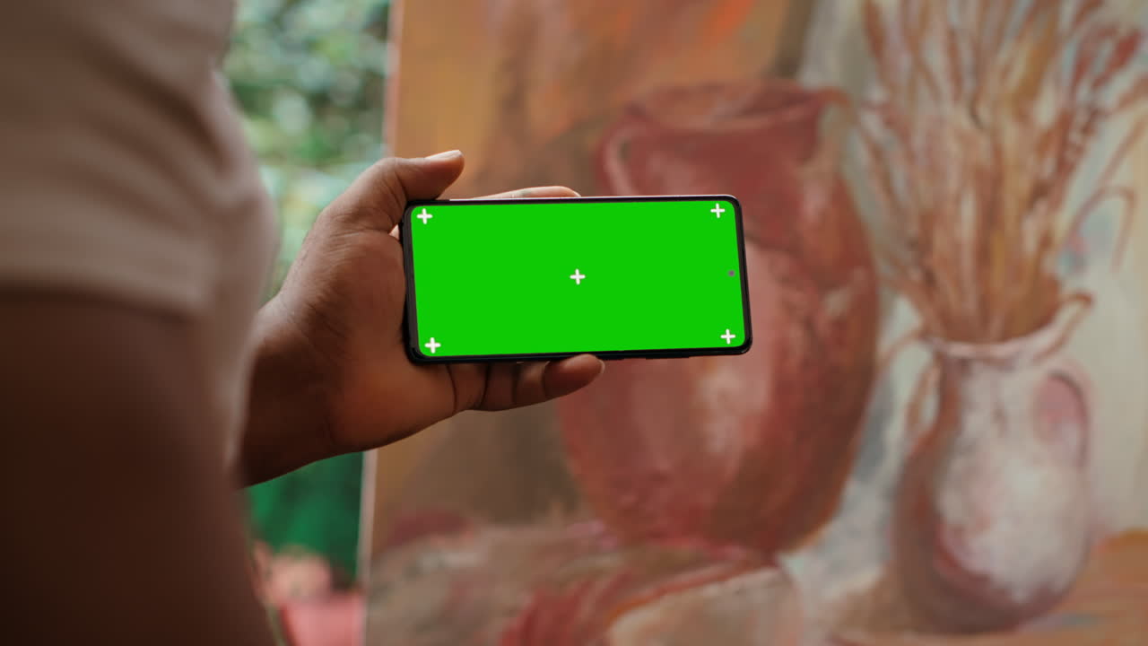 Smartphone with Green Screen in front of a Painting