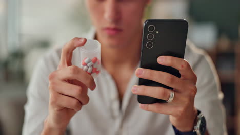 person using phone while holding pills