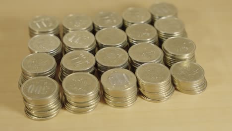 Stacks-of-500-Yen-Coins-on-Table,-Japanese-Money-Close-Up