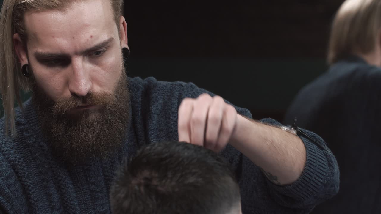 Barber cutting a client's hair in a barbershop
