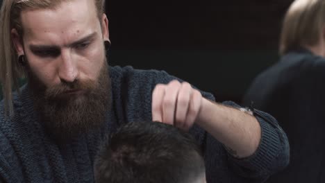 barber cutting a client's hair in a barbershop