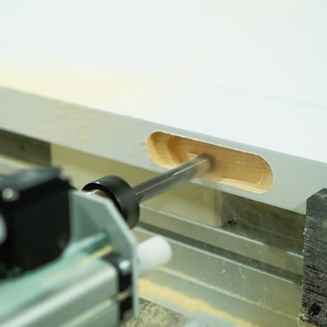 machine tool for making doors. process of manufacturing wooden doors on production equipment. door industry. close-up.
