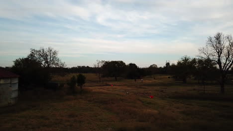 Low-aerial-dolly-toward-a-couple-of-horses-relaxing-in-a-field