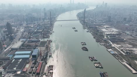 huangpu river and industry area with lujiazui downtown in background