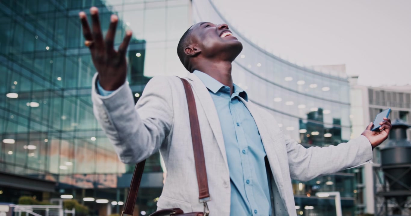 Excited Businessman Celebrating Success Outside Modern Office Building