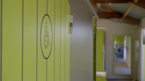 green boxes at changing room with lockers, sign of invalid on char on one of them, safe and secure storage of clothes, personal belongings in primary schools, gyms, sport and leisure centers concept