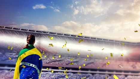 animación de confeti flotando sobre la espalda de una mujer con bandera brasileña en el estadio