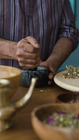 grinding herbs with mortar and pestle
