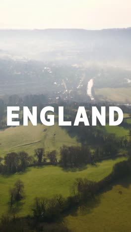 vertical video aerial drone shot of fields and countryside in uk with graphic spelling out england