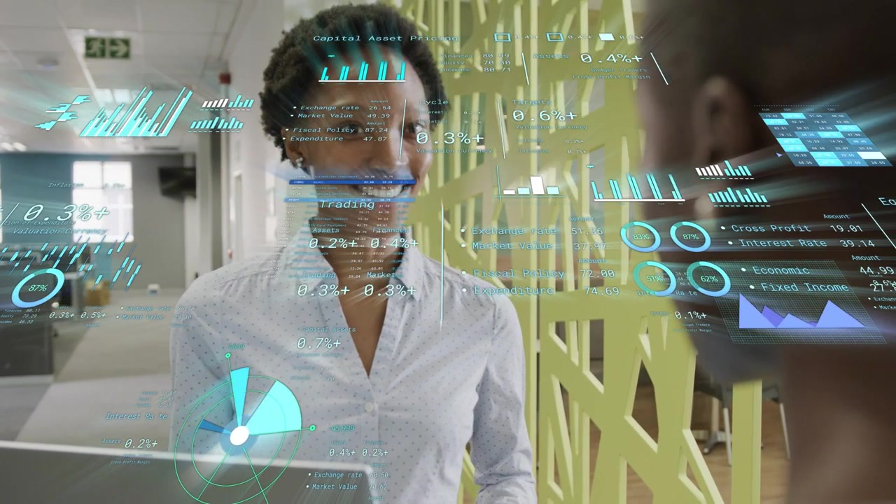Woman standing at laptop looking down and initiating animated analytics charts for business review