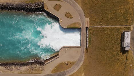 Stunning-top-view-of-Hydro-dam-and-man-made-canal-at-Lake-Pukaki,-NZ