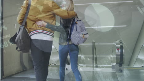 animation of infographic interface over rear view of biracial couple getting down by escalator