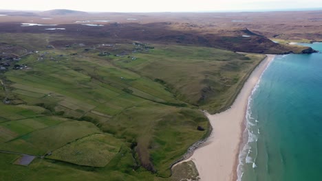 high elevation drone shot of traigh mhor beach with tolsta village in the background on the outer hebrides of scotland