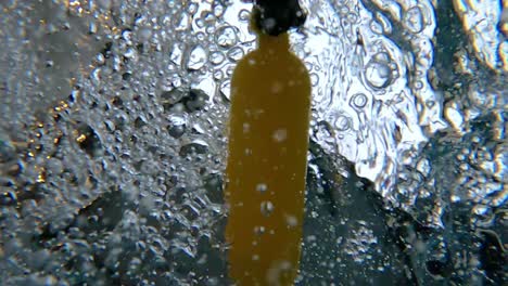 Under-water-oxygen-tube-floating-on-surface-in-pool,-Close-up