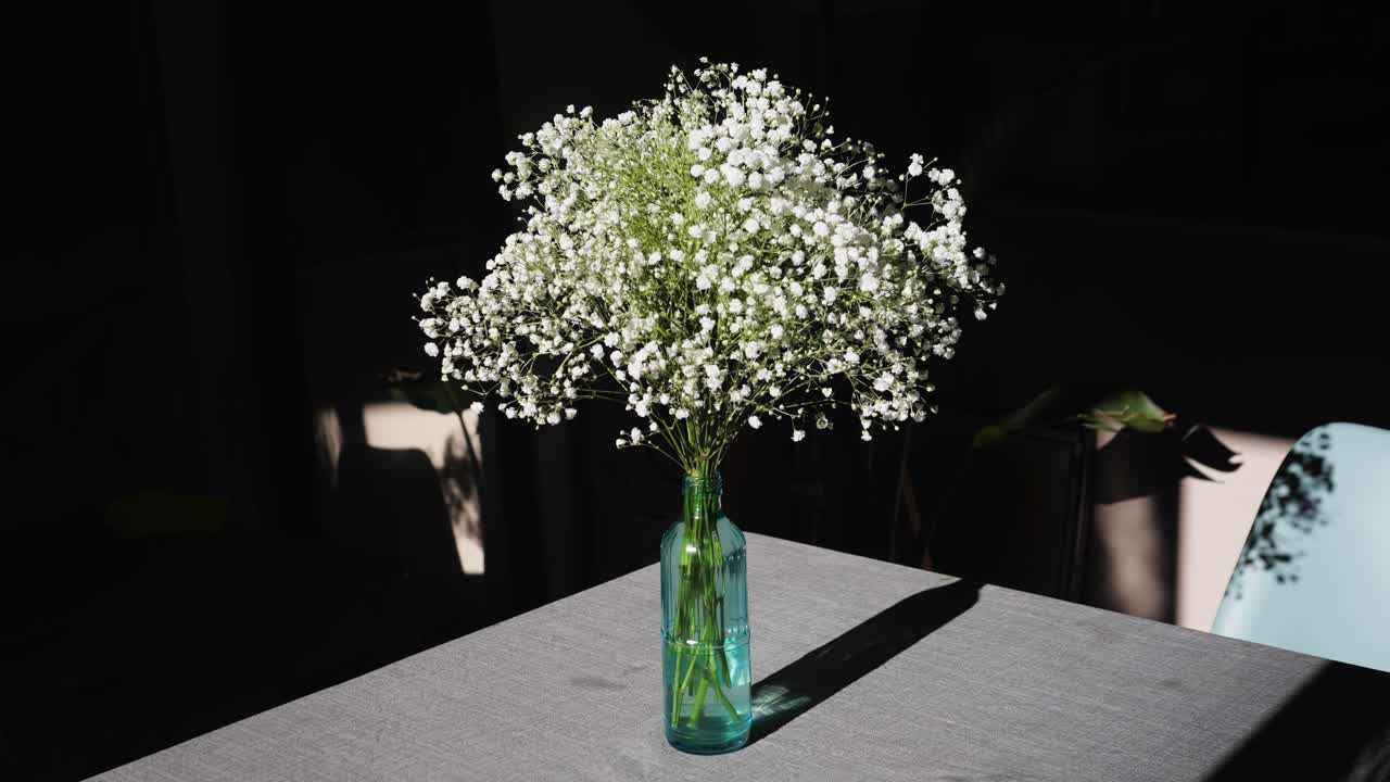 gypsophila graceful on table, white flowers close-up with a blurred background at home. Natural background for design or as texture. Summer plants.