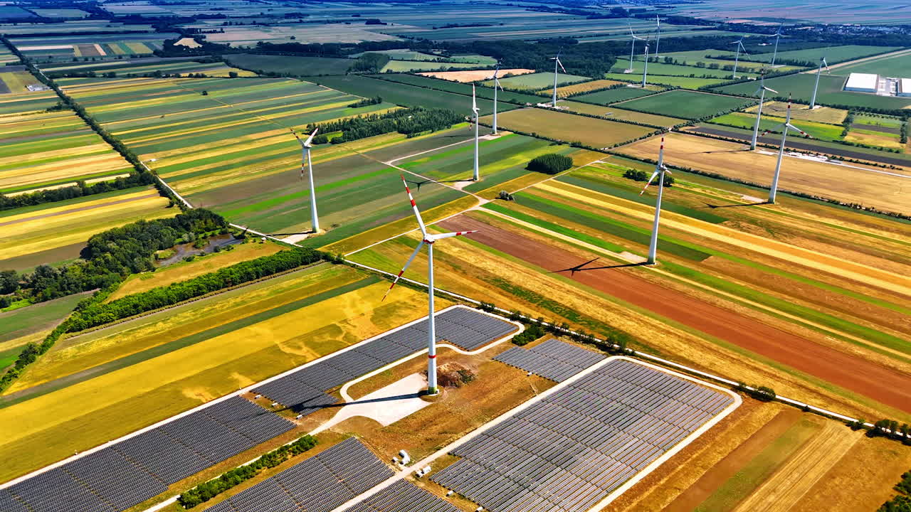 Wind and solar energy fields. Wind turbines and solar panels thrive in vibrant fields, symbolizing the beauty of sustainable energy