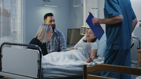 family visiting a sick teenager in hospital