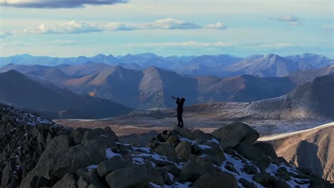 shofar ram horn music blown from hiker top of rocky mountains summit jewish christian tradition walls of jericho mt mount shavano elbert huron peak central colorado aerial drone sunset snow static
