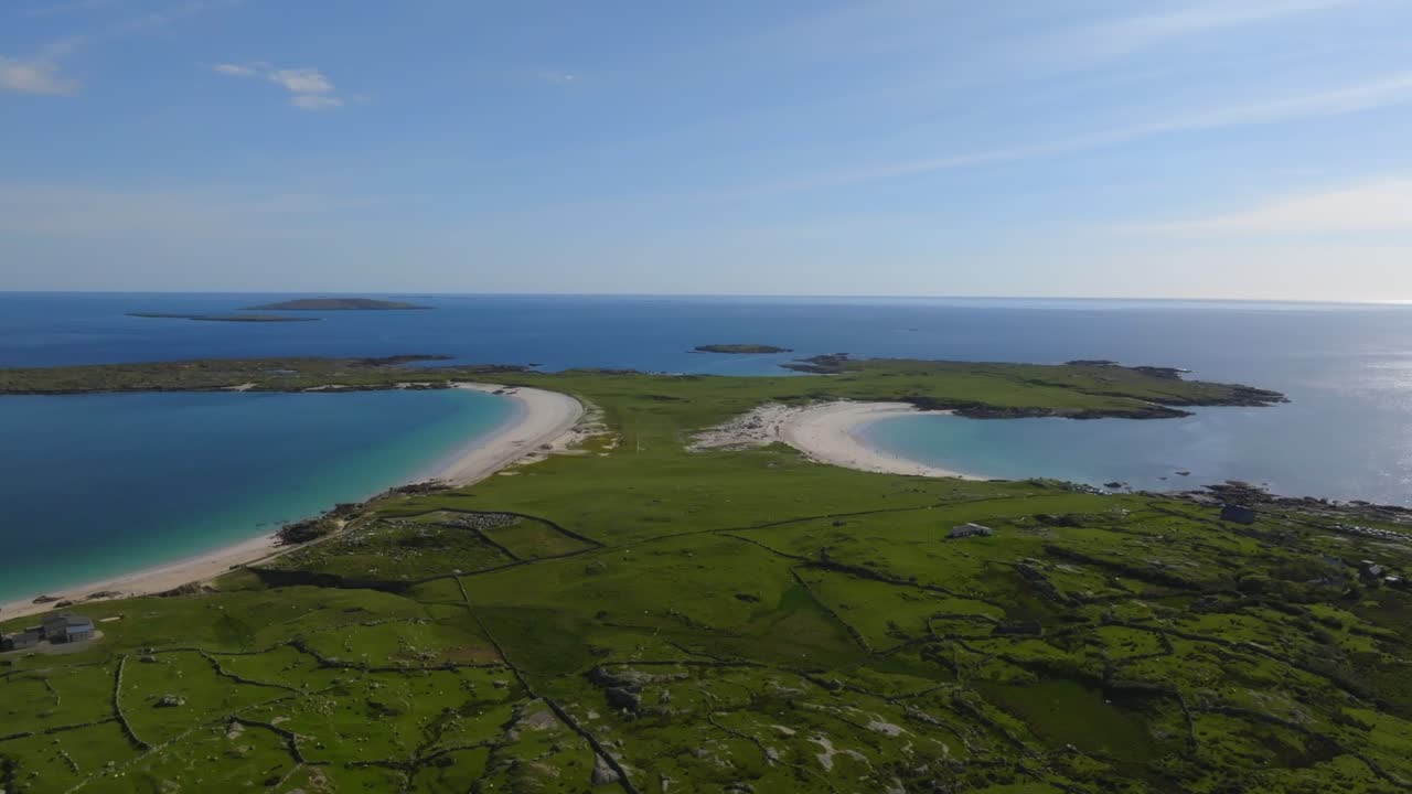 Dog's Bay Beach, Roundstone, Connemara, County Galway, Ireland, May 2025. Drone orbits counterclockwise aerial view of twin crescent beaches on wild Atlantic way with clear waters and coastal views