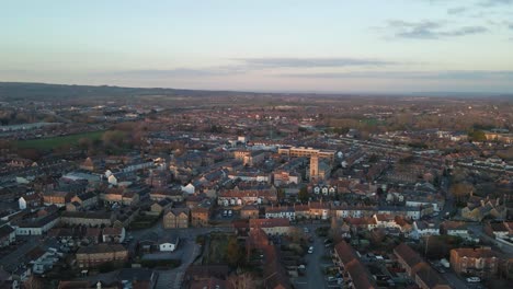 4K-aerial-view-of-taunton-Somerset,-United-Kingdom,-drone-moving-forward-and-showing-the-blue-sky-with-some-clouds