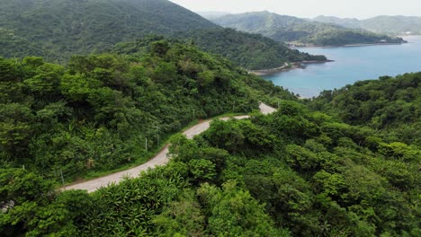 breathtaking view of countryside road passing through hill forest,aerial