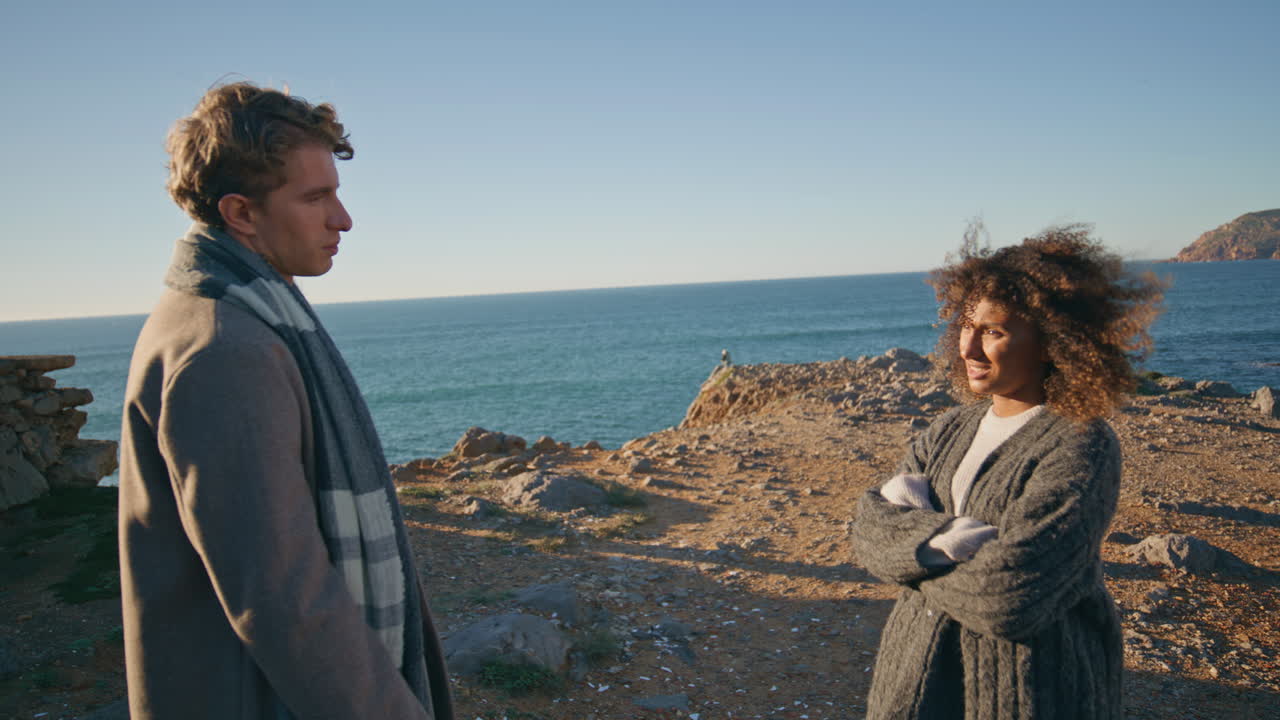 Offended wife arguing husband emotionally in seashore closeup. Couple crisis