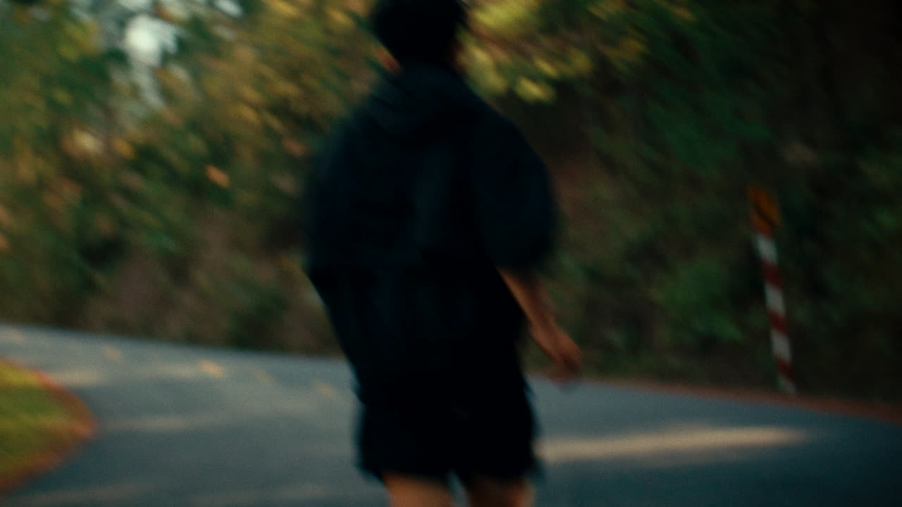 Man Running on a Road through Forest