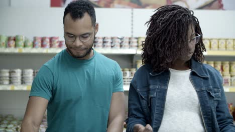 focused people buying groats in store