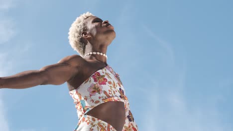 transgender woman breathing clean air while enjoying freedom standing with open arms.
