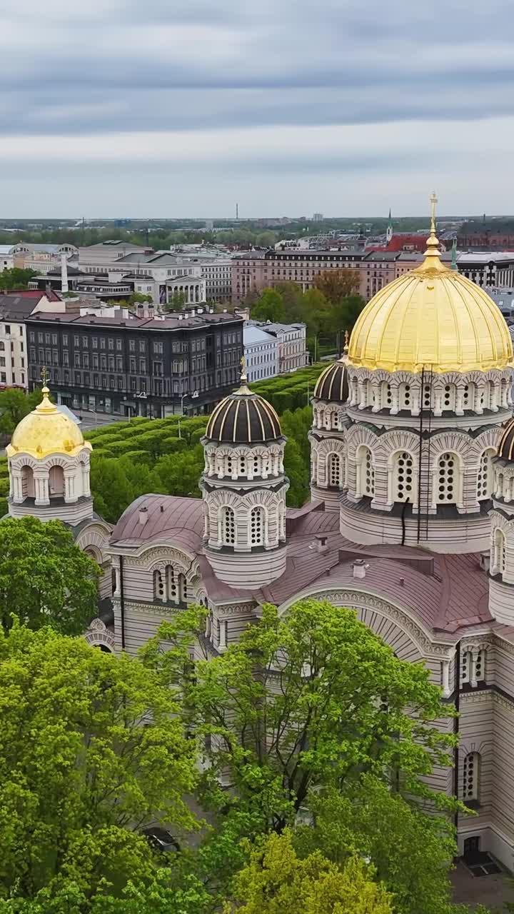 Soar above Riga's iconic cathedral, showcasing its Neo-Byzantine architecture and vibrant city backdrop - Vertical