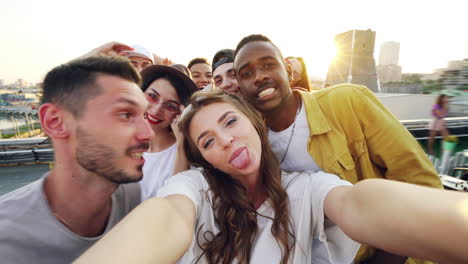 happy friends taking a selfie on a rooftop