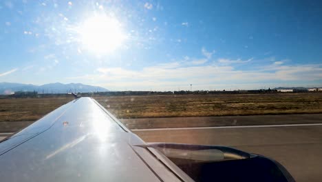 Taxi down the runway for takeoff at Salt Lake City International Airport - motion hyper lapse from plane window