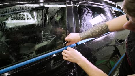 man covering car with vinyl polyurethane tape. films for the car. sticker protective film on the car