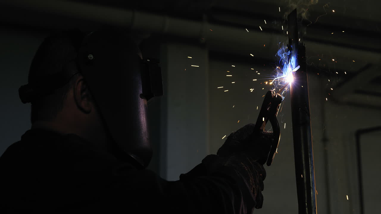 сварщик, сваривающий металл