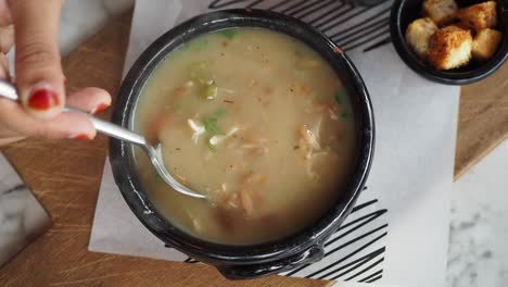 woman eating creamy soup