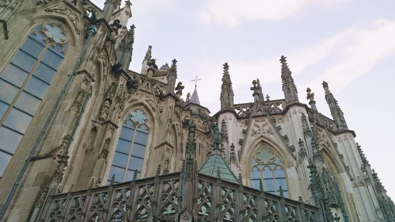 Saint John's Cathedral in 's- Hertogenbosch Den Bosch in Netherlands, rotating low angle view of the building, sky, chapels and spires, authentic traditional Dutch European architecture style design