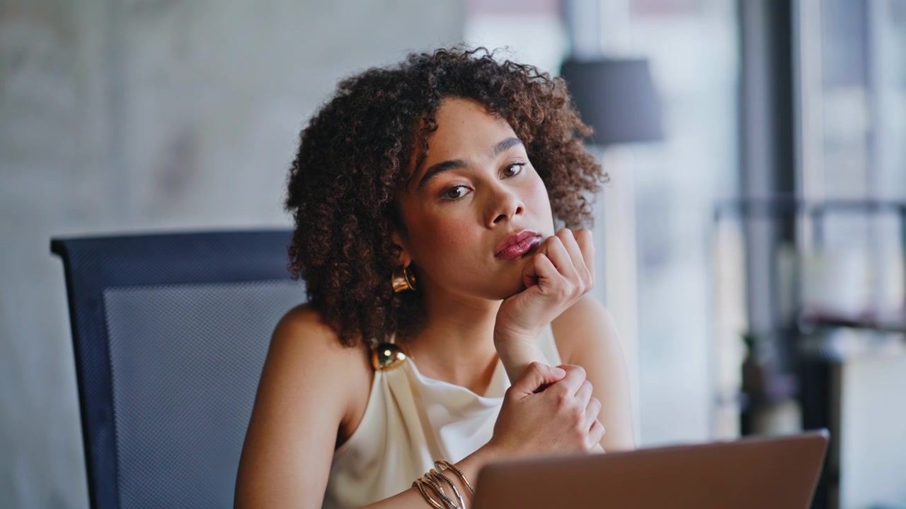 Thoughtful woman contemplating laptop. Close up african american freelancer