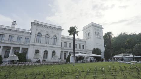 exterior of a white palace with gardens