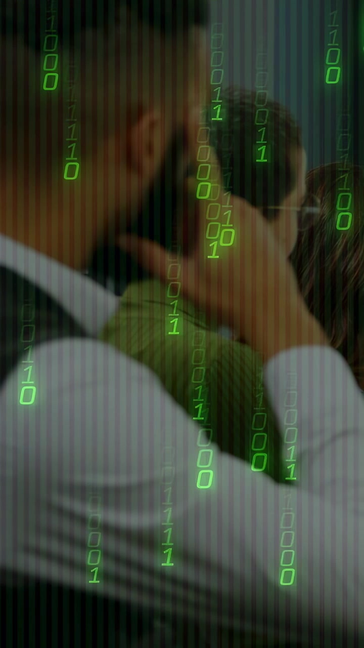 Vertical video: Close-up showing man cupping partner head, showing care, green binary tech overlay