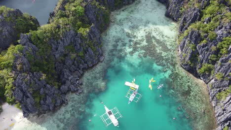 scenic aerial over dramatic limestone karsts and small lagoon, el nido palawan