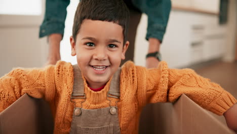caja de mudanzas, diversión y cara de niño en la casa de la familia