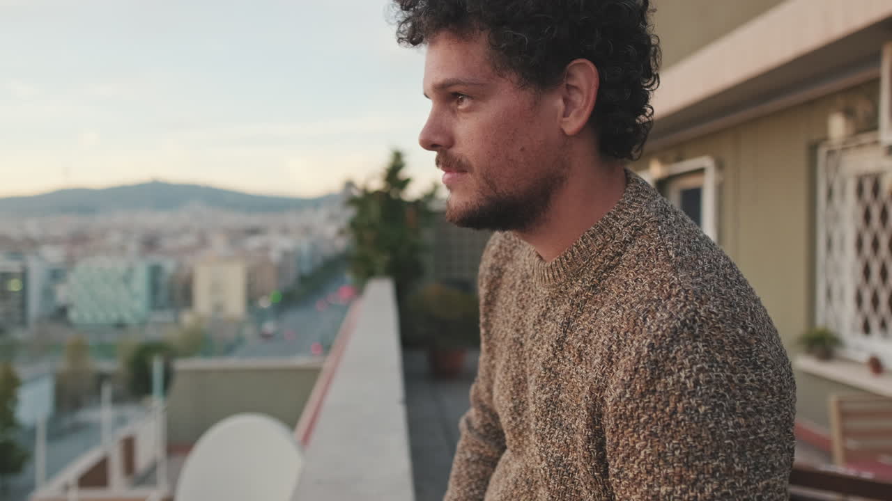 Man on Balcony Overlooking City