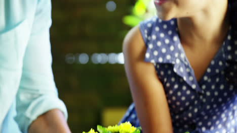 grandmother and grand daughter smelling flowers