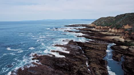 dramatic ocean cliffs on the west coast with waves crashing against rocks