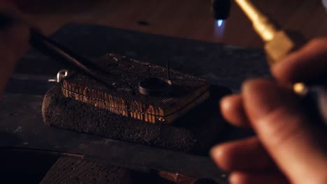 Goldsmith-crafting-ring-by-burner