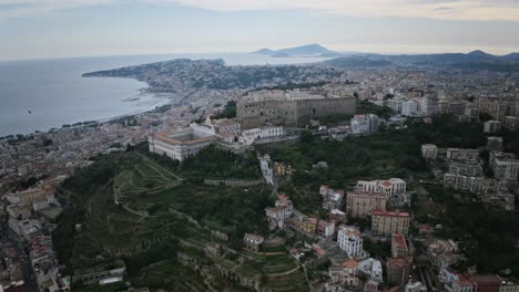 wide aerial hyperlapse of castel sant'elmo with dusk sunset happening in the background