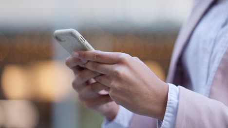 businesswoman texting an email on her phone