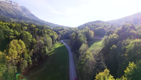 aerial shot of a red car driving on